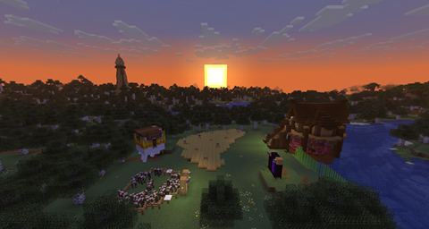 A sunset lights a house with a tall tower in the background